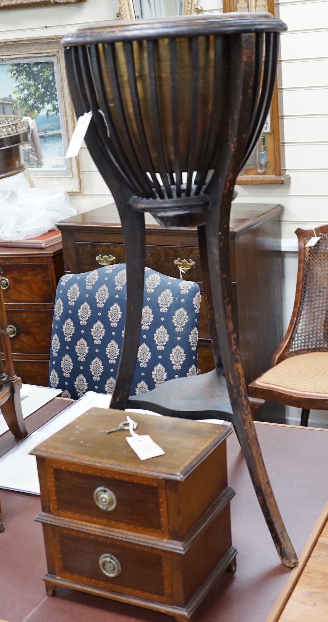 An Edwardian ebonised jardiniere stand with brass liner, width 46cm, depth 46cm, height 85cm, and a miniature two drawer chest *Please note the sale commences at 9am.